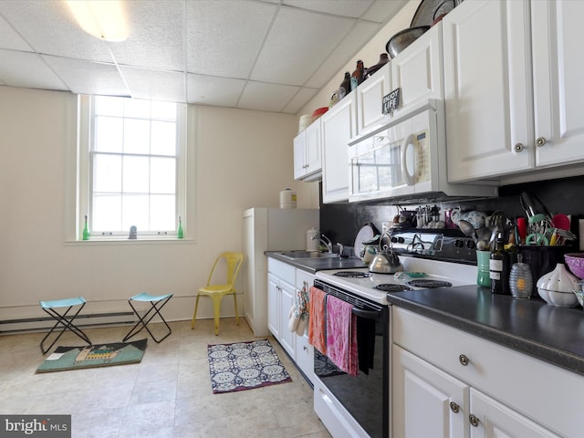 kitchen featuring white cabinetry, white appliances, a paneled ceiling, and a sink