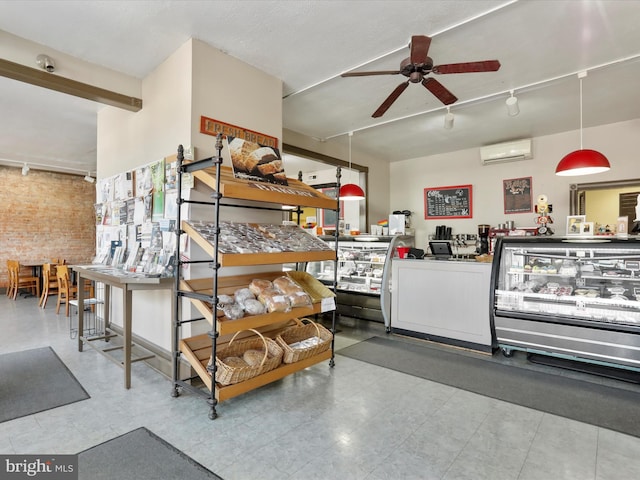 interior space featuring track lighting, brick wall, a ceiling fan, and a wall unit AC