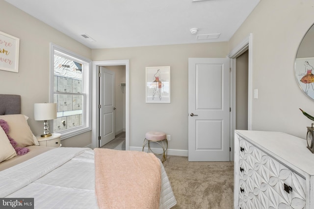 bedroom with light carpet, visible vents, and baseboards