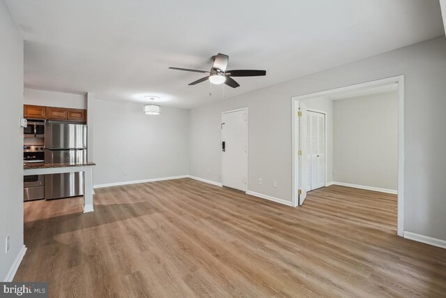 8358 Dunham Ct Unit 626, Springfield, VA 22152 - unfurnished living room with baseboards, a ceiling fan, and wood finished floors