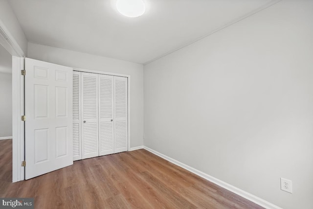 8358 Dunham Ct Unit 626, Springfield, VA 22152 - unfurnished bedroom featuring wood finished floors, baseboards, and a closet
