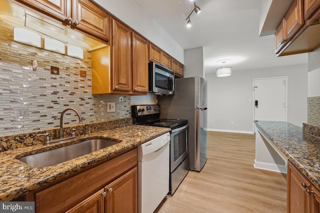 8358 Dunham Ct Unit 626, Springfield, VA 22152 - kitchen with a sink, light wood-type flooring, decorative backsplash, brown cabinetry, and appliances with stainless steel finishes