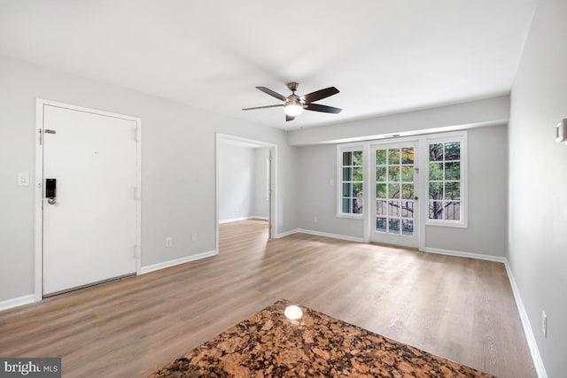 8358 Dunham Ct Unit 626, Springfield, VA 22152 - unfurnished living room featuring wood finished floors, a ceiling fan, and baseboards
