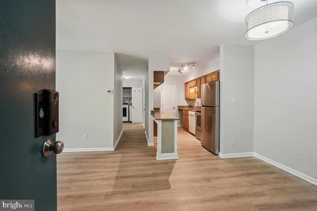 8358 Dunham Ct Unit 626, Springfield, VA 22152 - kitchen with light wood-style flooring, baseboards, freestanding refrigerator, stone countertops, and brown cabinets