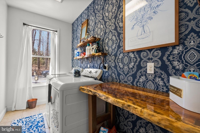 laundry room with washing machine and clothes dryer, tile patterned flooring, wallpapered walls, and laundry area