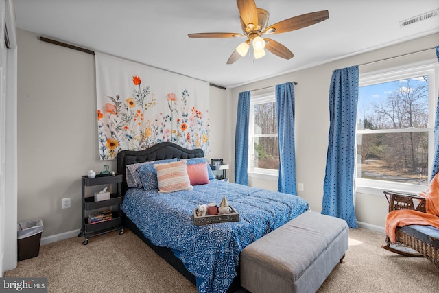 bedroom featuring carpet flooring, baseboards, visible vents, and ceiling fan