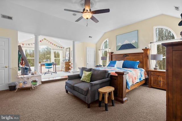 carpeted bedroom with vaulted ceiling, decorative columns, and visible vents