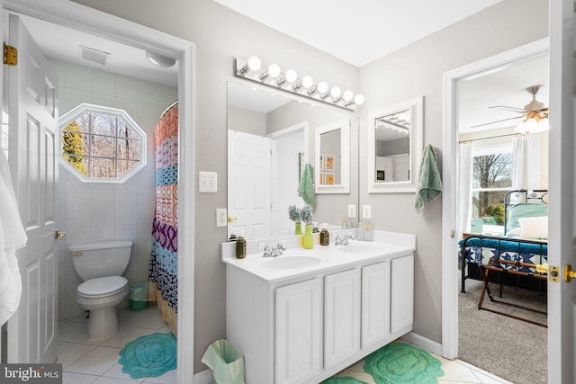 bathroom with tile patterned floors, toilet, visible vents, and a sink