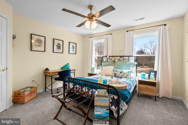 carpeted bedroom featuring a ceiling fan, baseboards, and visible vents