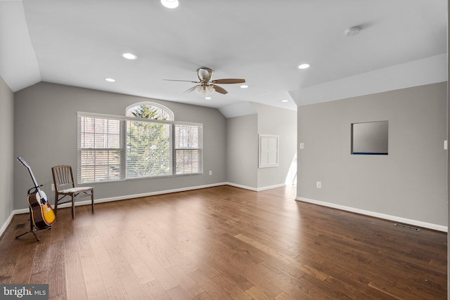 unfurnished room featuring dark wood finished floors, visible vents, a ceiling fan, and lofted ceiling