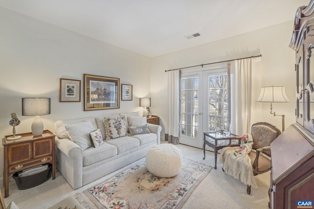 living room featuring visible vents and light colored carpet