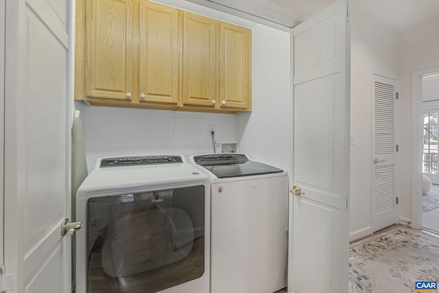 laundry room with washing machine and clothes dryer, cabinet space, and baseboards