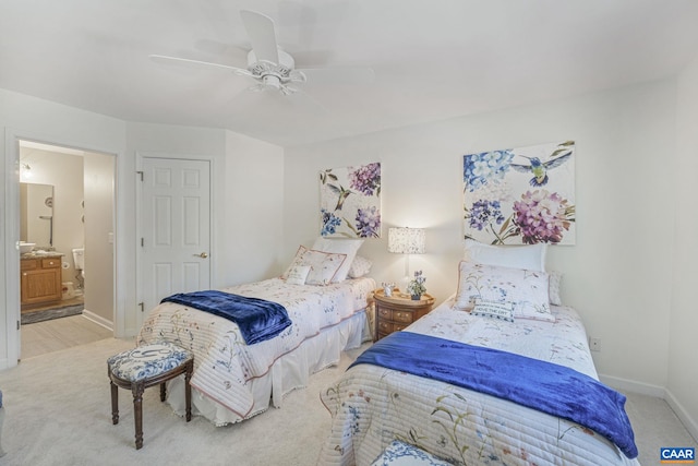 carpeted bedroom featuring connected bathroom, baseboards, and ceiling fan