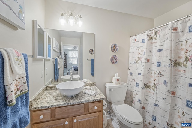 full bath with toilet, vanity, and a shower with curtain