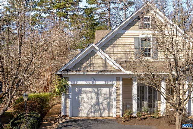 view of front of property with aphalt driveway and a garage