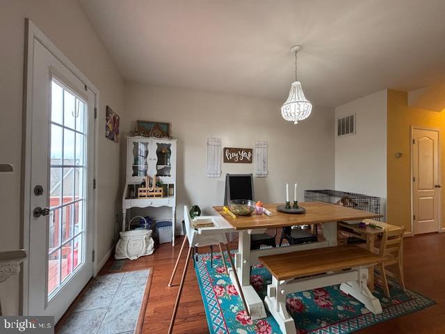 dining area featuring visible vents and wood finished floors