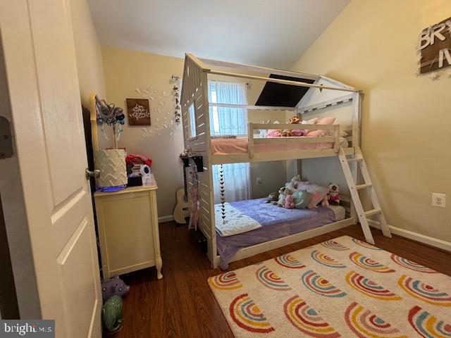 bedroom featuring baseboards and wood finished floors