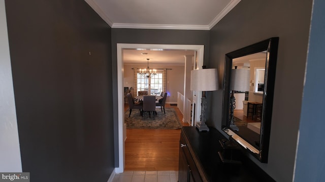 interior space featuring ornamental molding, light tile patterned floors, a notable chandelier, and baseboards