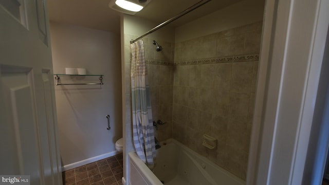 bathroom with baseboards, shower / tub combo, toilet, and tile patterned flooring