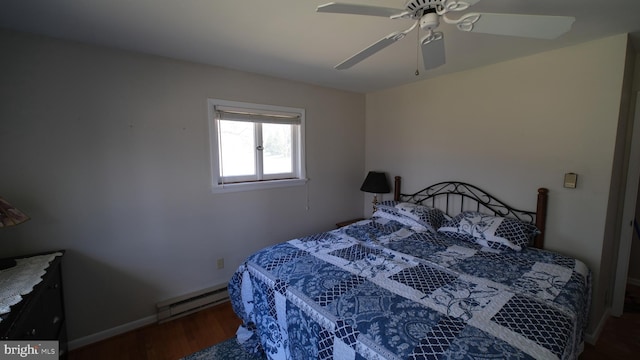 bedroom featuring baseboards, ceiling fan, wood finished floors, and a baseboard radiator