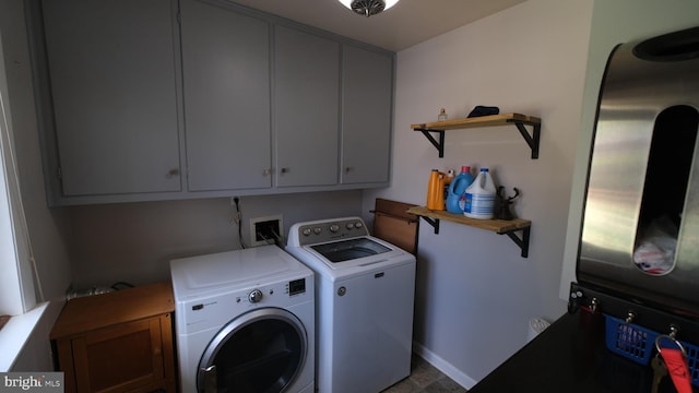 laundry room with baseboards, washing machine and dryer, and cabinet space