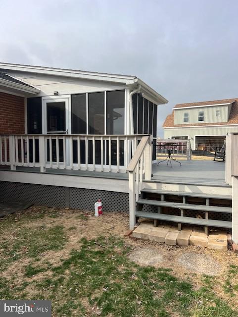 exterior space featuring a deck and a sunroom