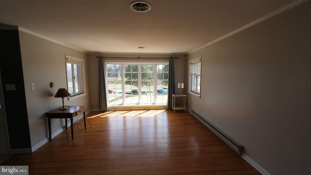 doorway with baseboards, wood finished floors, a baseboard heating unit, and ornamental molding