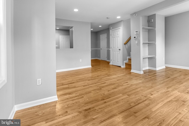 interior space featuring light wood finished floors, recessed lighting, and baseboards