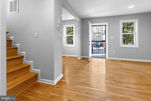 foyer entrance featuring baseboards, visible vents, recessed lighting, stairs, and light wood-type flooring