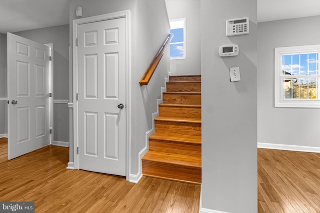 stairway with baseboards and wood-type flooring