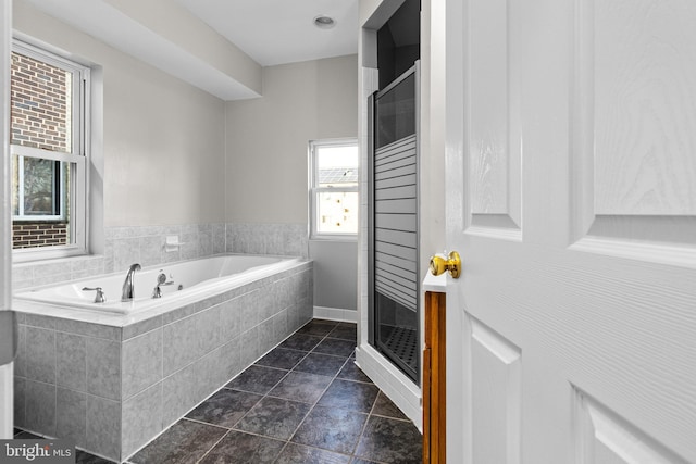 full bath with tile patterned flooring, a shower stall, and a garden tub