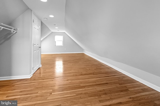 bonus room featuring lofted ceiling, recessed lighting, light wood-style floors, and baseboards