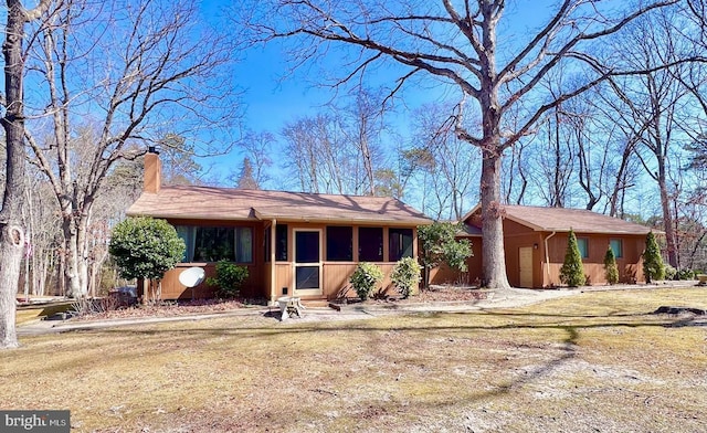 ranch-style house featuring a chimney