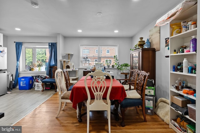 dining space with recessed lighting and wood finished floors