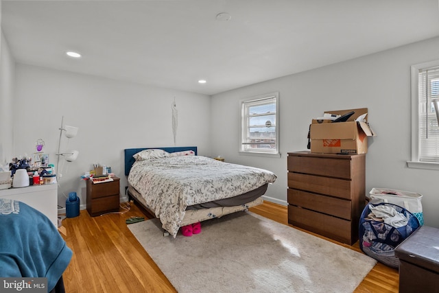 bedroom with recessed lighting, baseboards, and light wood-style floors