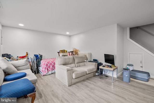 living room with recessed lighting, stairway, baseboards, and wood finished floors