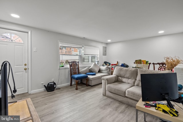 living room featuring recessed lighting, light wood-type flooring, and a healthy amount of sunlight