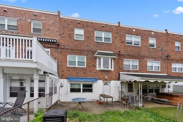 back of property featuring brick siding