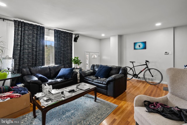 living area with recessed lighting and wood finished floors