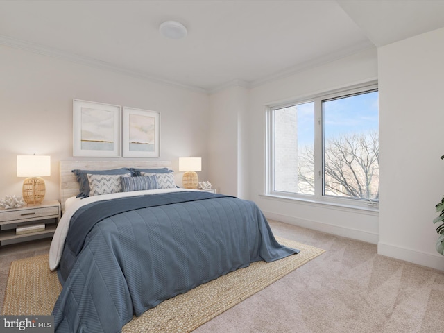 carpeted bedroom featuring crown molding and baseboards