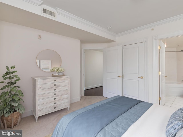 bedroom featuring visible vents, ensuite bath, baseboards, and ornamental molding