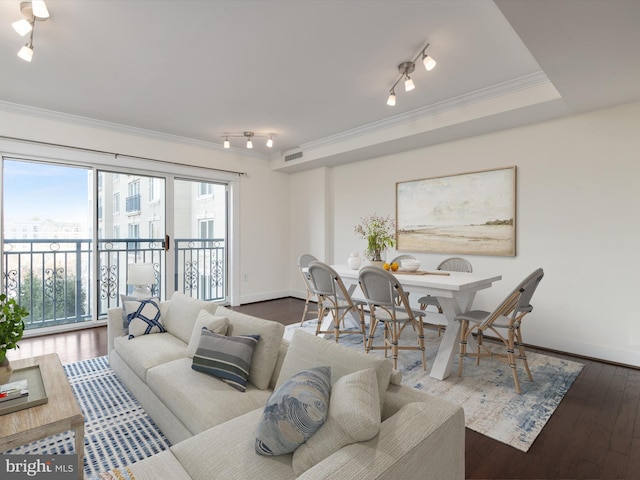 living room with visible vents, crown molding, baseboards, and wood finished floors