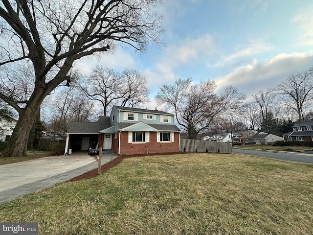 bungalow-style home with brick siding, an attached carport, fence, a front yard, and driveway