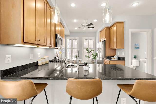 kitchen featuring a peninsula, recessed lighting, appliances with stainless steel finishes, and ceiling fan