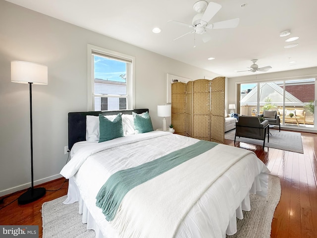 bedroom featuring wood-type flooring, a ceiling fan, recessed lighting, and multiple windows