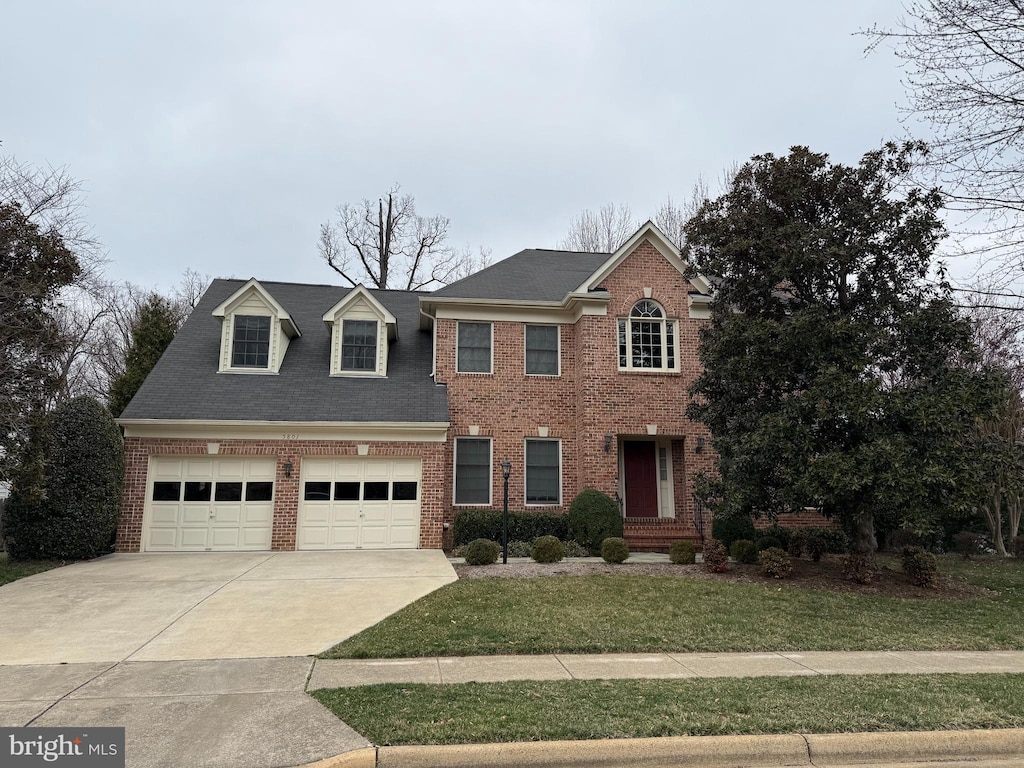 view of front of house featuring concrete driveway, brick siding, a garage, and a front yard