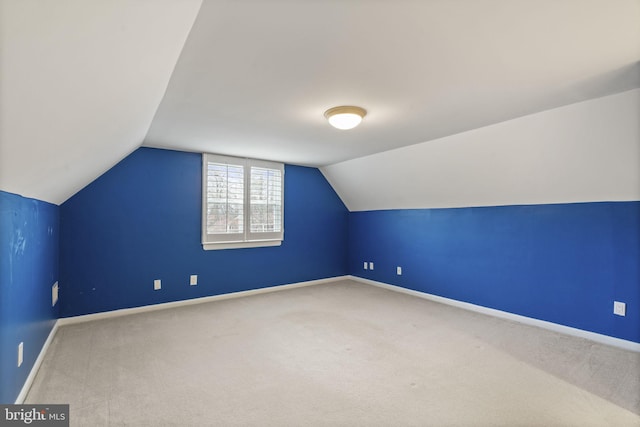 bonus room featuring carpet flooring, baseboards, and lofted ceiling