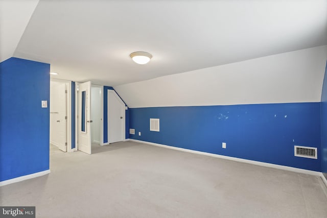 bonus room featuring visible vents, baseboards, lofted ceiling, and carpet floors