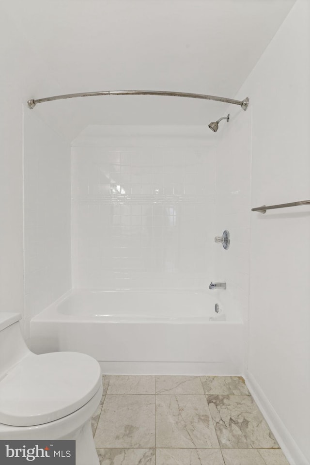 full bathroom with shower / tub combination, toilet, and marble finish floor