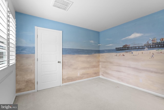 carpeted empty room featuring baseboards and visible vents